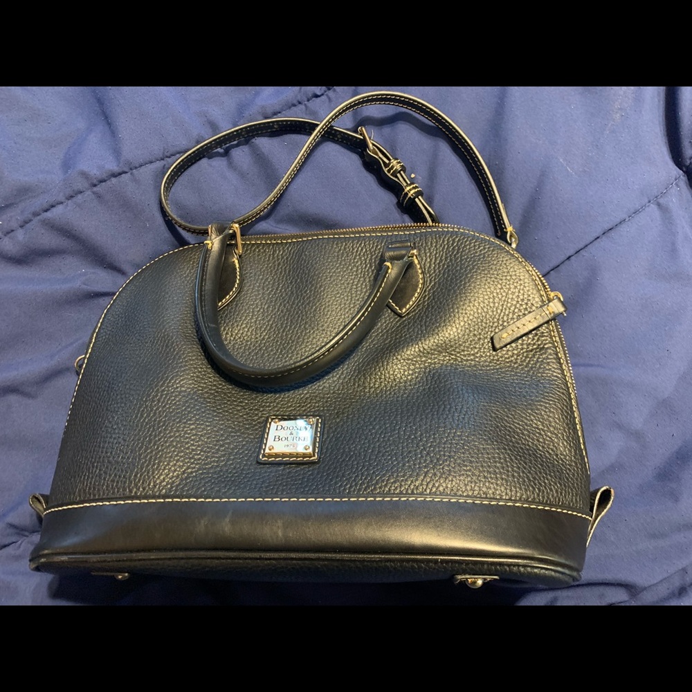 Black leather with red inside. Detailed stitching, in perfect condition nwot.